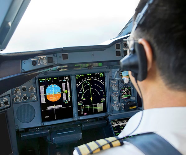 Image of a pilot in an Airbus A380 cockpit