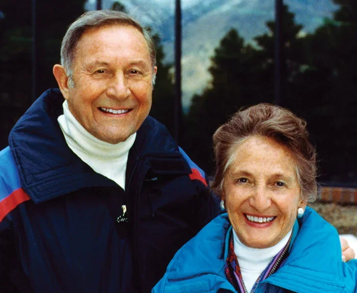 Founders Bill and Vieve Gore posing for a photo in front of a mountain.