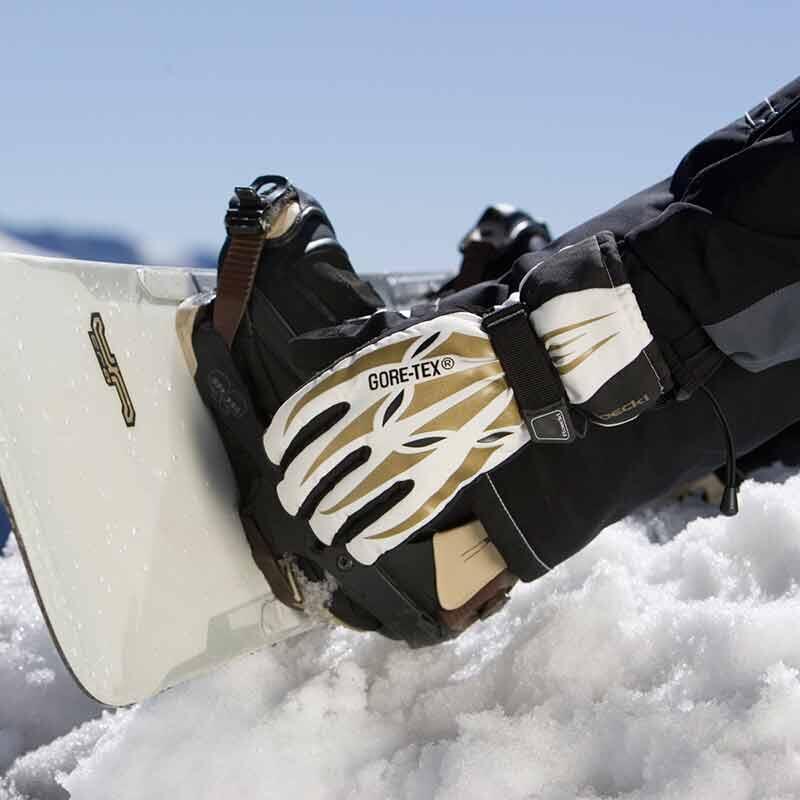 Close up image of a snowboard and GORE-TEX gloves